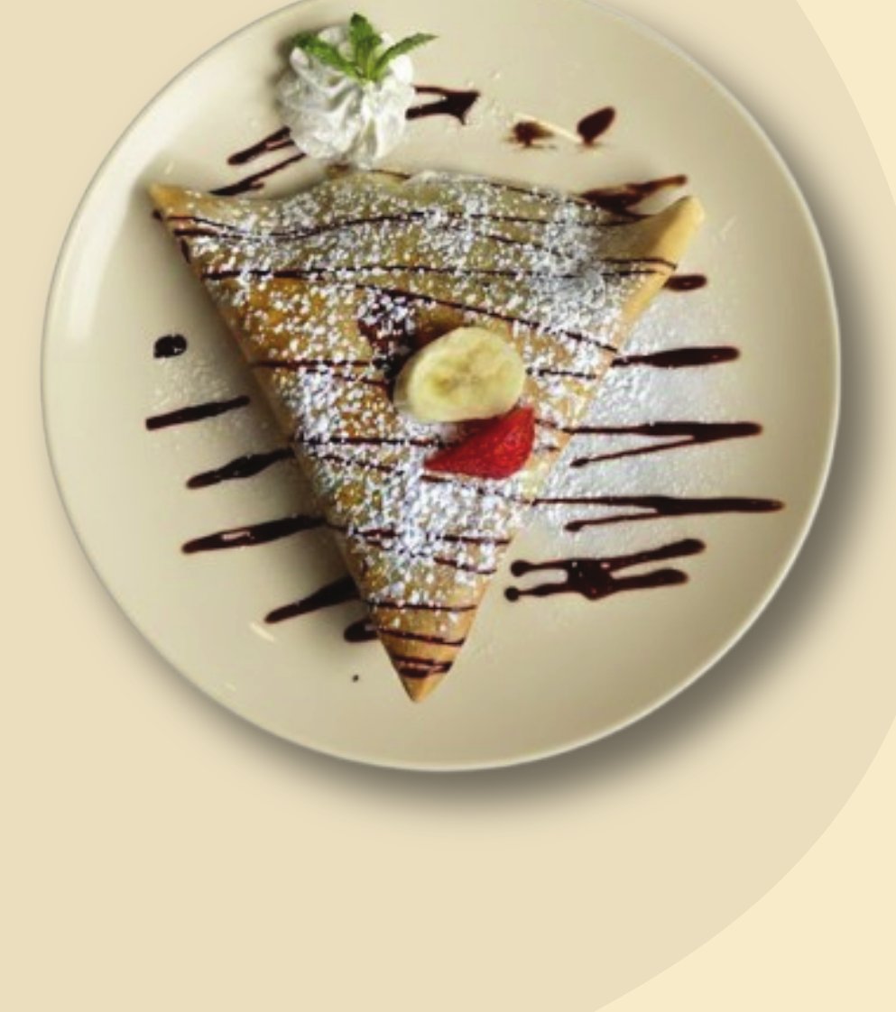 Sweet crêpe triangle with banana, strawberry and chocolate drizzle